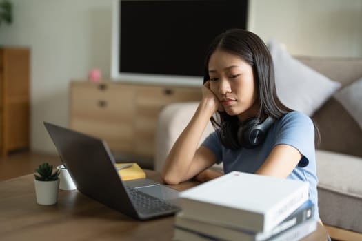 Studying online, beautiful Asian female student show symptoms burnout syndrome student studying online at home.