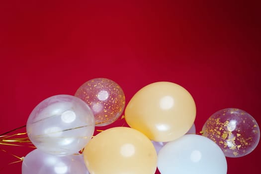 A bunch of light balloons on a red background. Vertical Photo Space for Text. High quality photo