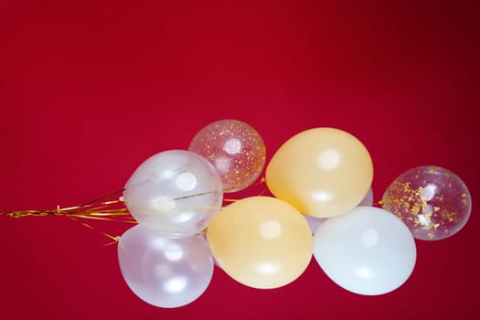 A bunch of light balloons on a red background. Vertical Photo Space for Text. High quality photo