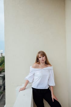 young woman in white blouse and black pants