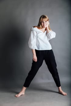 young woman in white blouse and black pants
