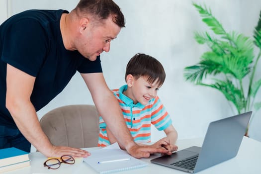 Man helping child studying at computer class