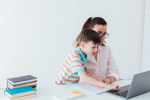 Woman with boy playing laptop