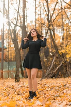 Close up portrait of pretty indian young woman enjoying warm autumn sunny day vacation outdoors. Generation z and gen z concept. Fall Season.