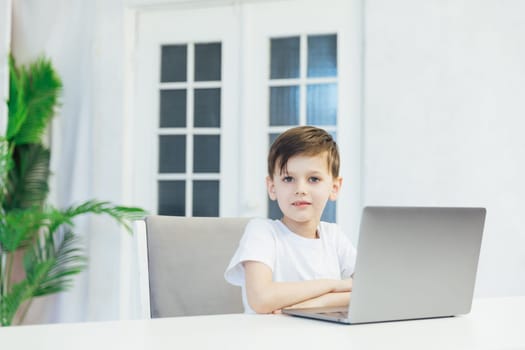 boy learns to work on a laptop