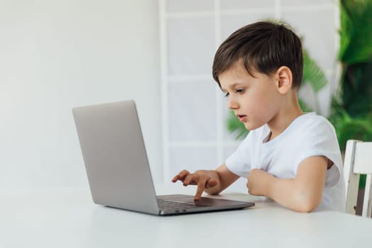 boy learns to work on a laptop