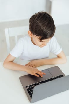 Little boy using laptop on white background