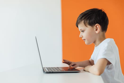 Young Boy Works on a Laptop For His New Project in His Computer Science Class.