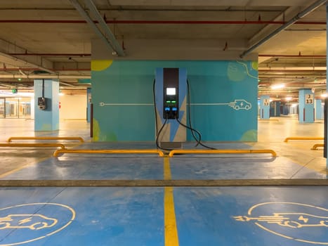 DC charging station to charge electric vehicles in the parking garage of the shopping mall