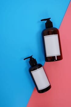 Body care. set of bottles with dispensers on a blue and pink background. Advertising concept. High quality photo