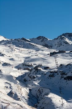 View of a snow track in Sierra Nevada (Spain) with chairlifts,