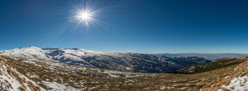breathtaking panoramic view of the sierra nevada in Granada, Spain, with starry sunshine,