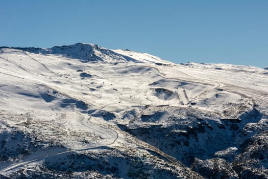 panoramic view of ski resort in sierra nevada, skiers along the slopes,