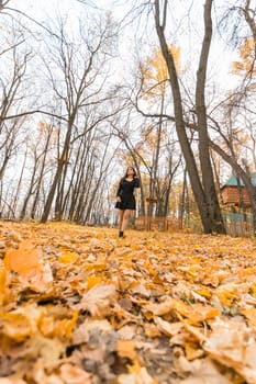 Close-up portrait of a young beautiful confident Indian Asian woman in fall outdoor. Happy and natural smiling female. Generation z and gen z youth