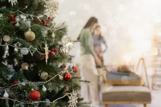 Young lesbian couple have party in holiday at home. decorate with christmas festival theme. selective focus.
