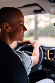 smiling woman driving his camper van through the countryside, concept of couple adventure travel and active tourism in nature