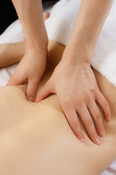 Female patient is receiving treatment by professional therapist.