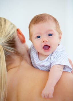 Family, shoulder and portrait of baby with mother in home for bonding, relationship and love. Happy, bedroom and closeup of parent carrying newborn for child development, growth and care in nursery.