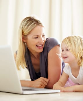 Online, learning and mom with girl on laptop with development, games and education in home. House, computer and mother with child in living room on website for growth and knowledge on internet.