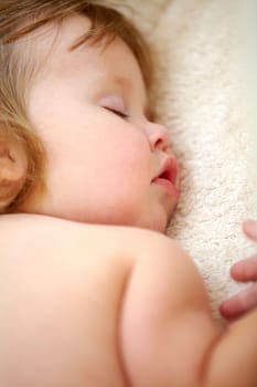 Closeup, baby and face for sleeping in nursery on bed for good dream, nap or rest. Toddler, little girl and relaxing on pillow for child growth with love, care and support for , cognitive development.