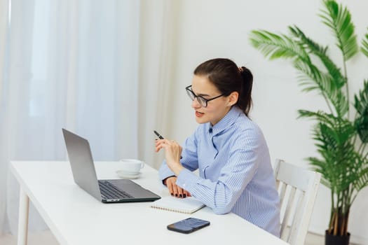 Smiling caucasian young businesswoman bank employee worker manager boss ceo looking at camera, using laptop for distant education work, e-learning, watching webinars online isolated in white