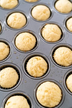 Cooling freshly baked American flag mini cupcakes on a kitchen counter.