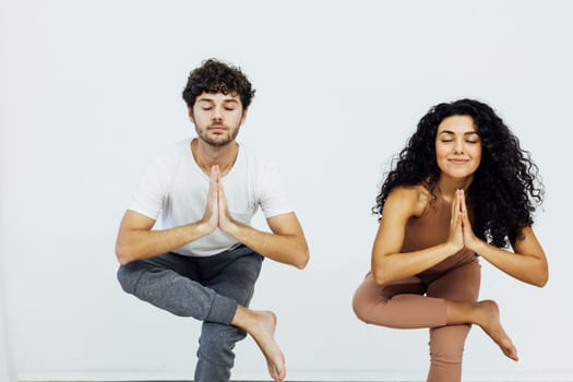 Man and woman doing yoga exercises meditation asana pose