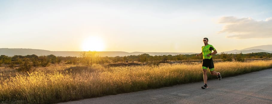 Triathlete in professional gear running early in the morning, preparing for a marathon, dedication to sport and readiness to take on the challenges of a marathon