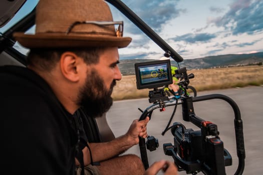 A videographer recording a triathlete riding his bike preparing for an upcoming marathon.Athlete's physical endurance and the dedication required to succeed in the sport