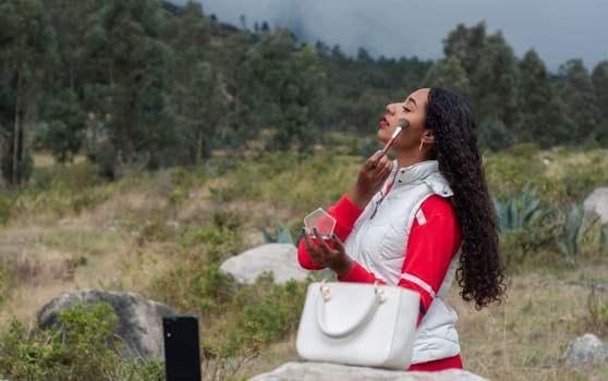 young woman from latin america teaching make-up in a live video on a mountain in ecuador . High quality photo