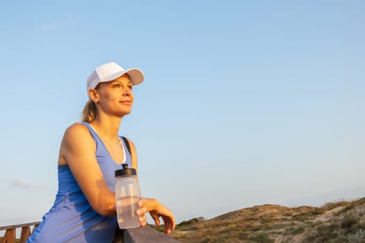 a girl of European appearance in sportswear stands outdoors, portrait of a girl in sportswear. High quality photo