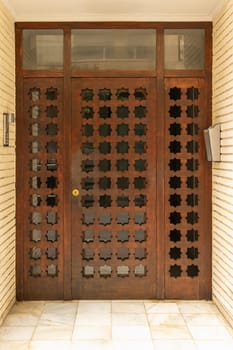 Old wooden entrance door to a house, door to a residential building, closed door, entrance to a residential building,. High quality photo