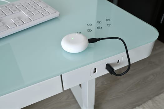 Box for wireless headphones is charged from USB table