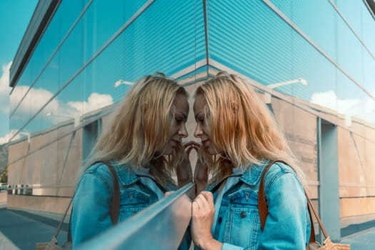 Portrait of a young woman in a denim jacket looking at a store window. High quality photo