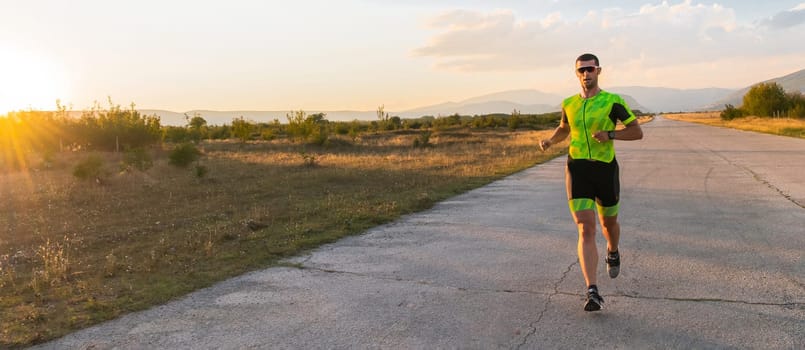 Triathlete in professional gear running early in the morning, preparing for a marathon, dedication to sport and readiness to take on the challenges of a marathon