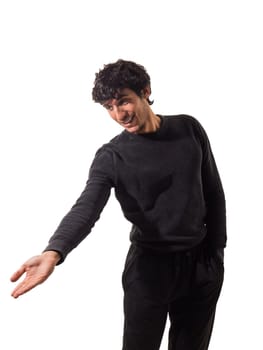 A handsome young man in a black sweater pointing at something, isolated on white