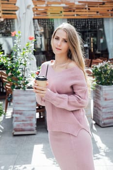 Woman near a restaurant with a glass walking