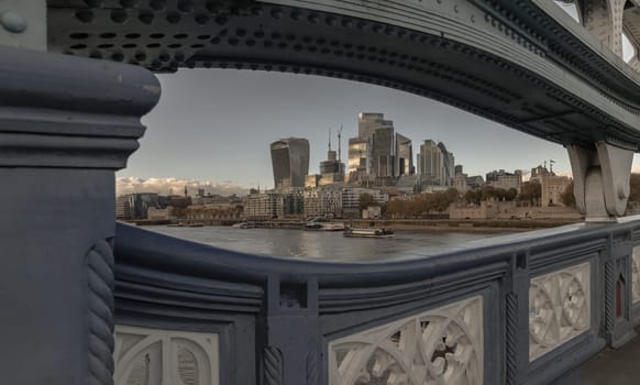 London, UK - Nov 07, 2023 - The skyscrapers in the business district of London and the River Thames. Looking through Structural and balustrade of the Tower Bridge, City of London view from Tower Bridge, Space for text, Selective Focus.