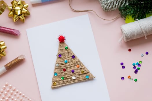 DIY Christmas Design. Decorative Origami Stars, Kraft Paper Envelopes, Greeting Cards, Wrapping Paper Rolls on White Background. Scandinavian Holidays Mockup.