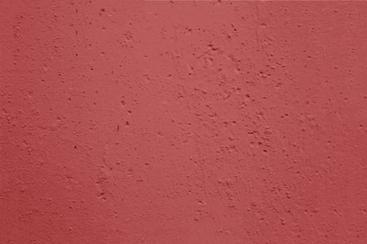 The surface of an old wall with red plaster damaged by time.