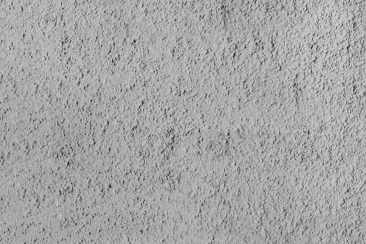 Rough texture of a gray concrete wall.