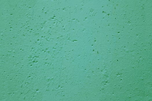 Texture of old green plaster on the wall.