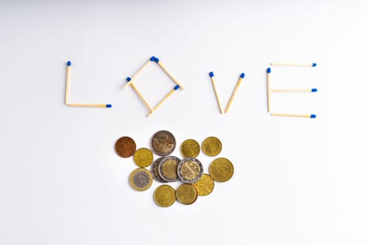 Word love from woodfire matches with an euro money coins and calculator