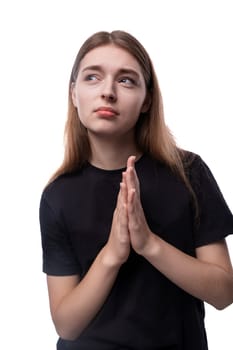 European cute schoolgirl girl with blond hair in a black T-shirt.