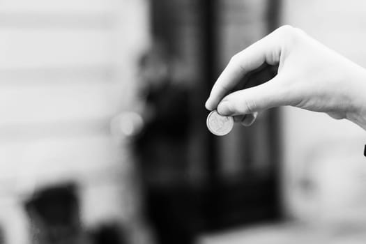 Street old performer musician plays saxofon blurred, coin in a hand focused