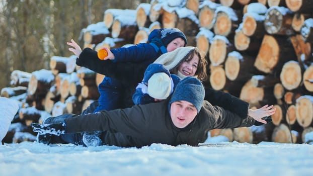 A happy family lying in the snow on a winter's day