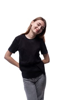 A 15 year old girl with brown hair is wearing a black basic T-shirt.