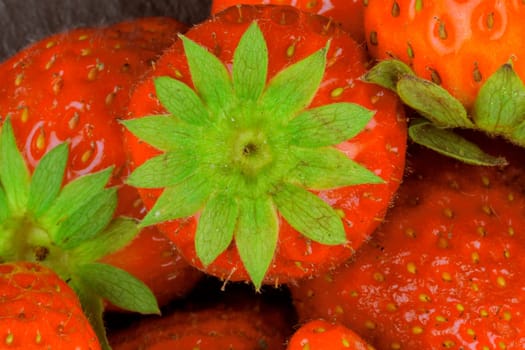 Color macro shot of strawberries. Strawberry image suitable as background for supermarkets, vegetable shops, garden market. Concept for restaurants, ice cream shops and fruit bars.