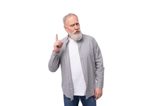handsome gray-haired elderly man in a shirt is inspired by an idea on a white background with copy space.