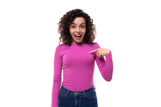 young well-groomed stylish curly brunette lady dressed in a purple turtleneck on a white background with copy space.
